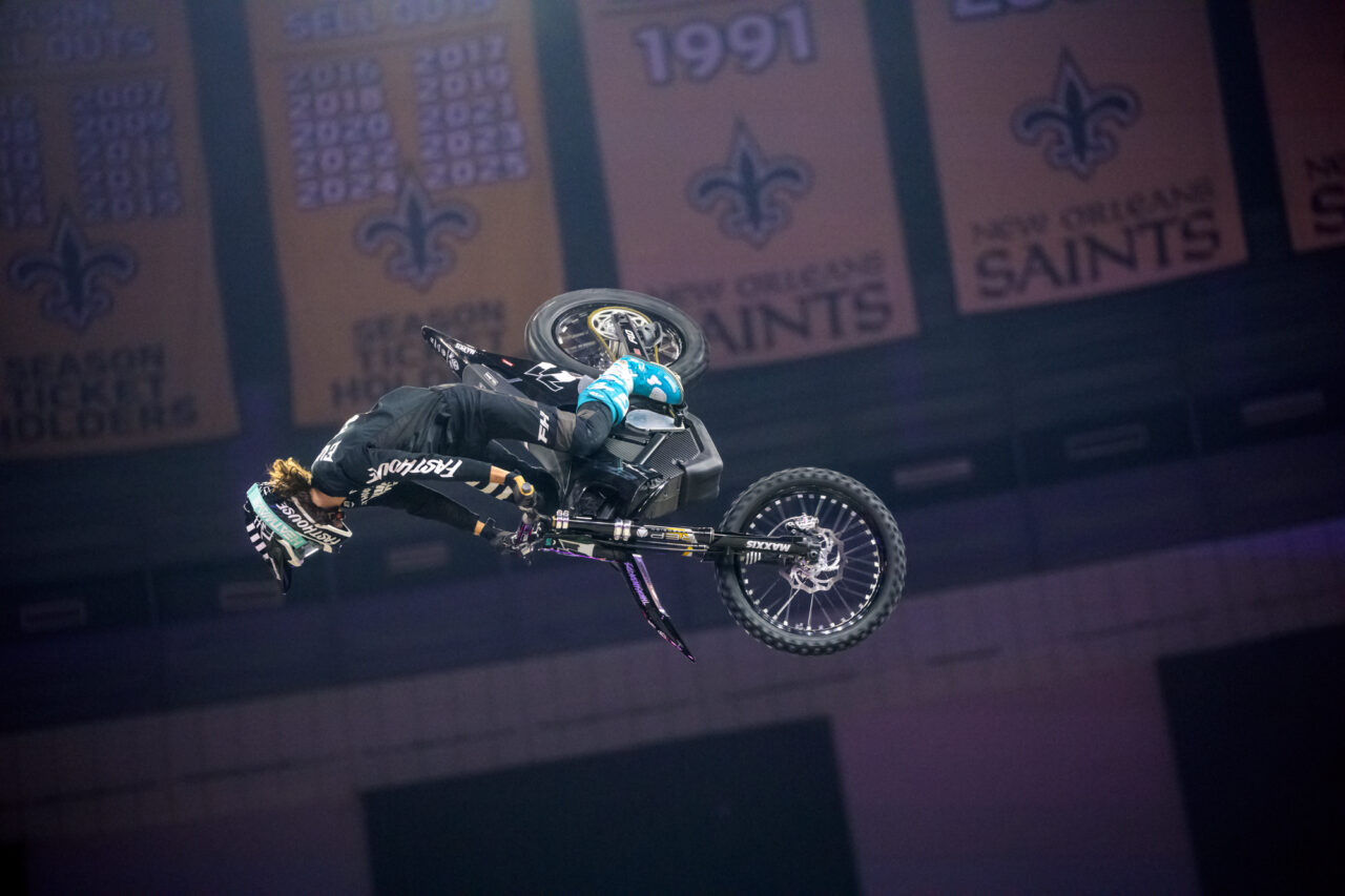 Pat Evans midflight and sailing past the NOLA championship banners hanging inside the Superdome.