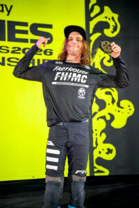 Pat Evans, hands lifted and holding a bronze medal on the podium at NOLA xgames.