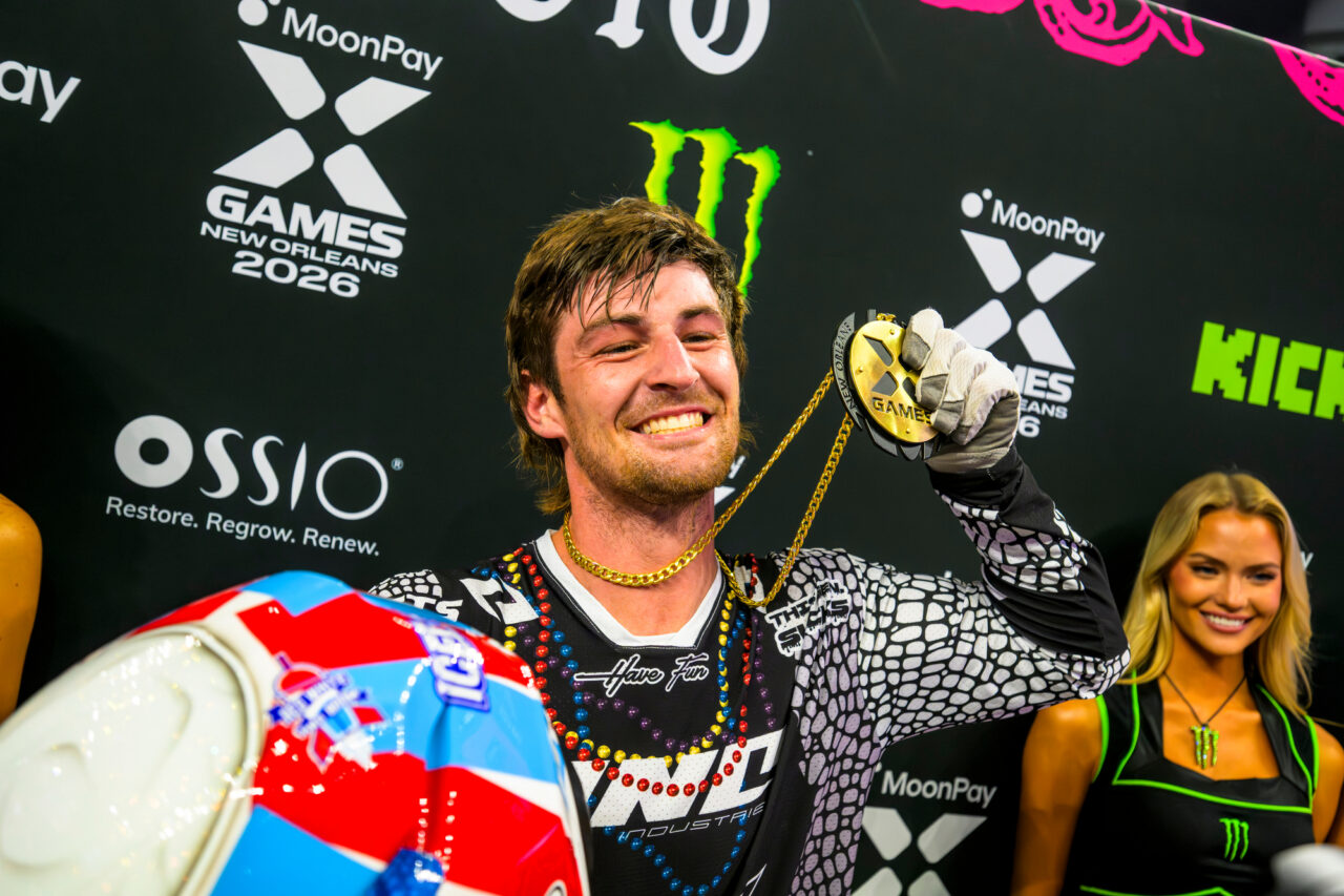 WYO on the podium holding his first Gold Medal with a very toothy smile.